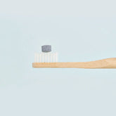 huppy toothpaste tablet on a toothbrush - charcoal mint